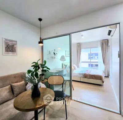 Modern studio apartment with cozy living area and bright bedroom