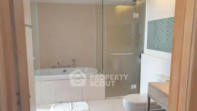 Modern bathroom with bathtub and glass shower enclosure