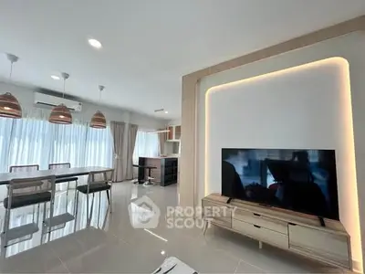 Modern open-plan living room with sleek furniture and natural light