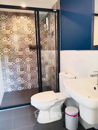 Modern bathroom with stylish patterned tiles and sleek fixtures