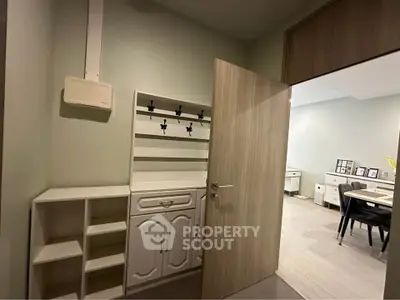 Stylish entryway with modern storage solutions and open view to dining area