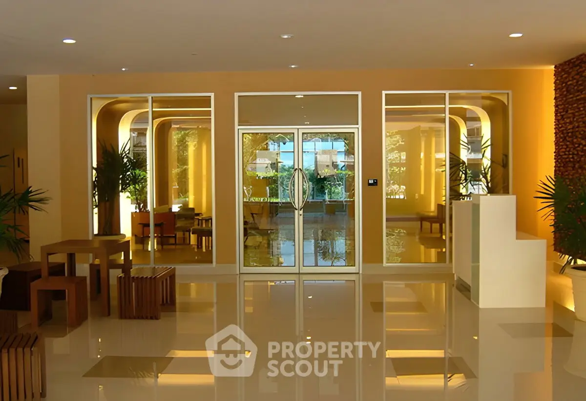 Elegant modern building entrance with glass doors and stylish decor