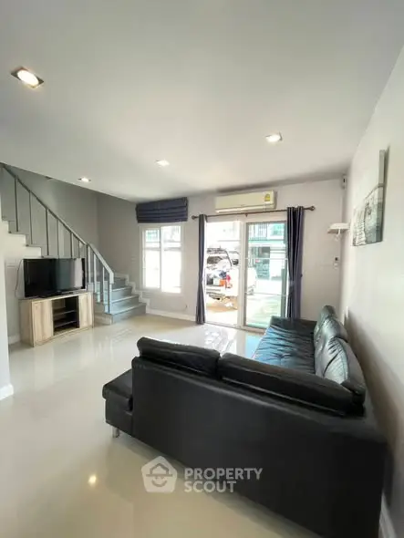 Spacious living room with modern decor and natural light