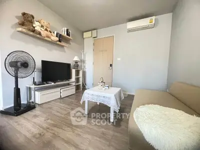 Cozy living room with modern decor and air conditioning, perfect for relaxation.