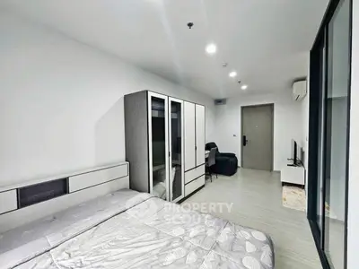 Modern bedroom with sleek furniture and minimalist design, featuring a comfortable bed and spacious wardrobe.