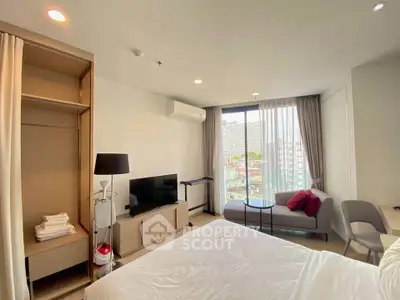 Modern bedroom with balcony view, stylish decor, and natural light