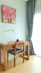 Cozy study room with wooden desk and chair, perfect for productivity.