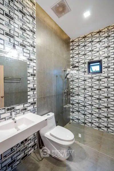 Modern bathroom with stylish tile design and glass shower enclosure