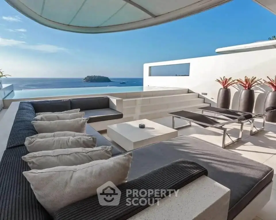 Luxurious rooftop terrace with stunning ocean view and modern seating area.