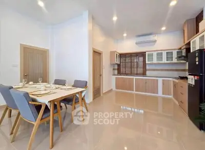 Modern open-layout kitchen and dining area with sleek design and ample natural light.