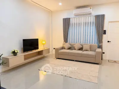 Modern living room with sleek furniture and air conditioning, perfect for relaxation.
