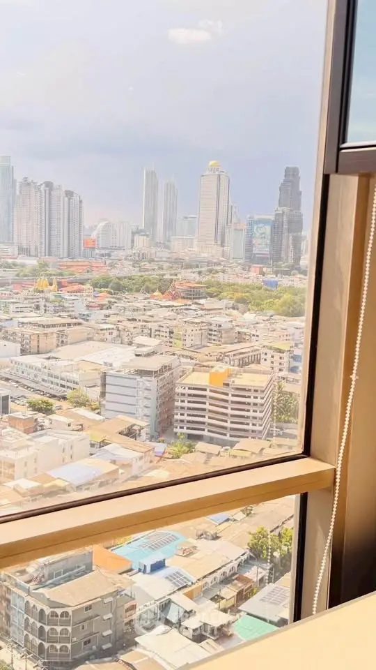 Stunning cityscape view from high-rise window, showcasing urban skyline.