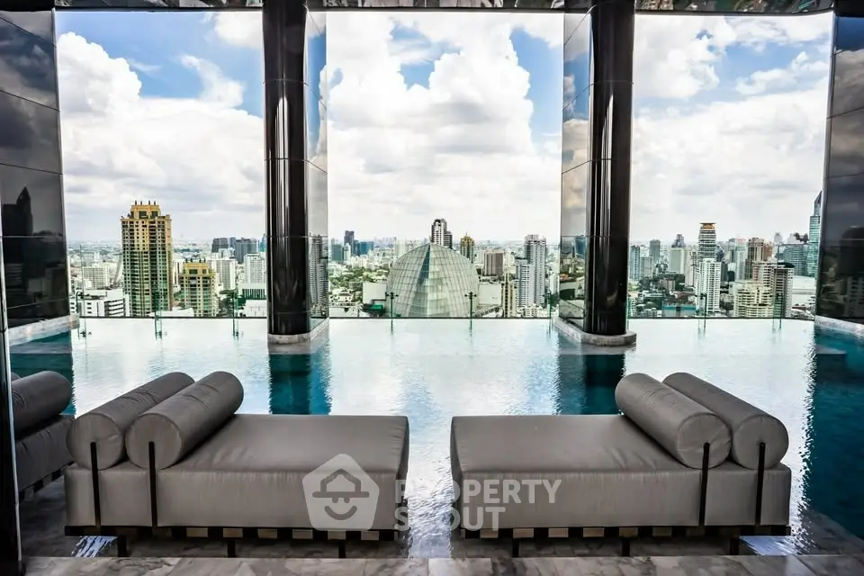 Luxurious rooftop pool with stunning city skyline view and elegant lounge chairs.