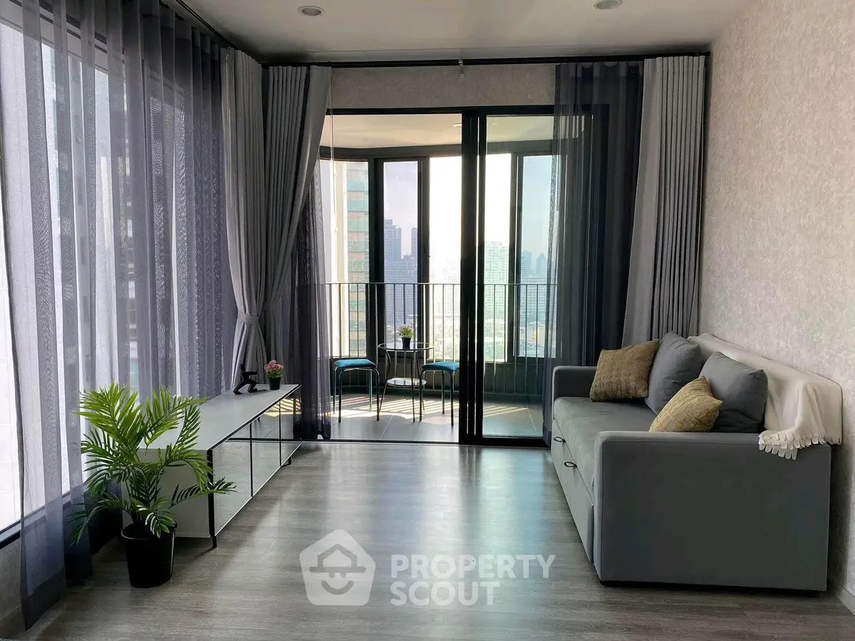 Modern living room with floor-to-ceiling windows and balcony view in urban apartment