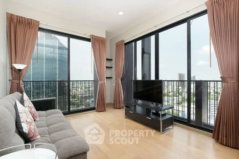 Spacious living room with floor-to-ceiling windows offering stunning city views in a modern apartment.