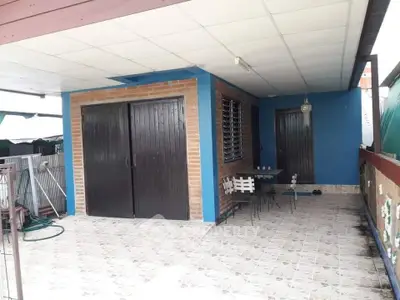 Charming covered patio with rustic brick accents and outdoor seating area.