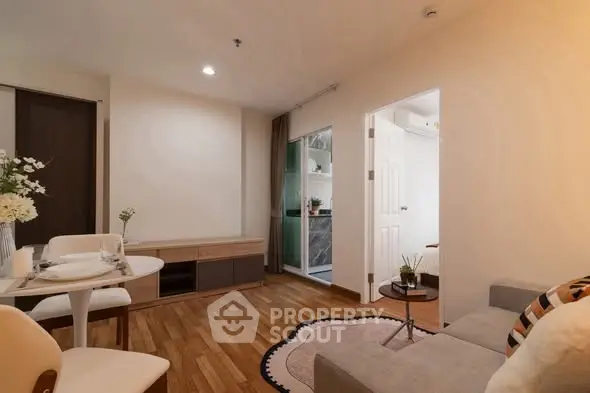 Cozy living room with modern decor and open view to adjacent room, perfect for urban living.