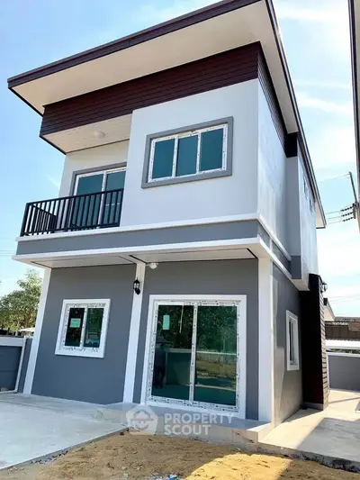 Modern two-story house with sleek design and large windows, perfect for contemporary living.