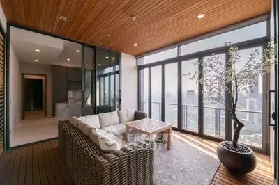 Luxurious balcony with stunning city view and modern seating area.