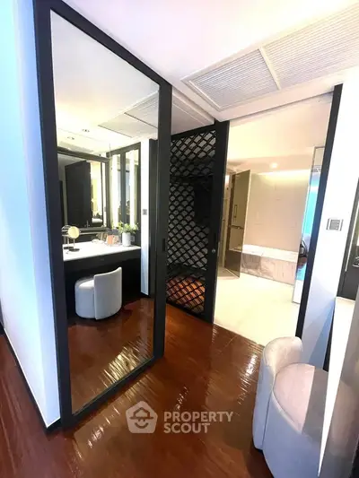 Luxurious modern interior with elegant bathroom and vanity area, featuring sleek design and high-end finishes.