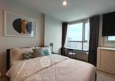 Modern bedroom with large window offering city view, stylish decor, and cozy bedding.