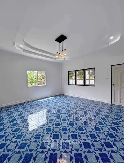 Spacious room with unique blue patterned tile flooring and modern lighting
