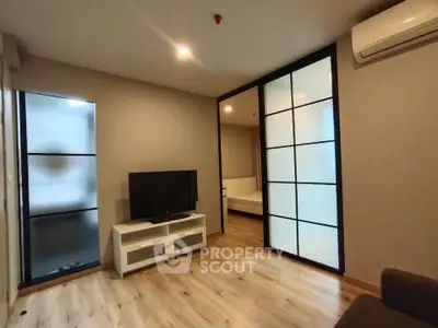 Modern living room with TV and sliding doors in stylish apartment