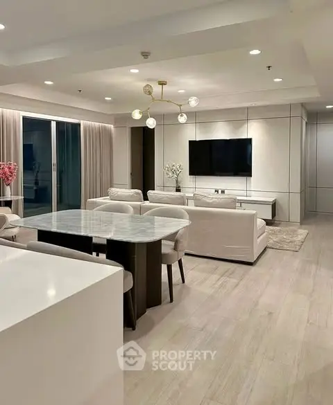 Luxurious open-plan living room with modern decor and elegant lighting in a high-end apartment.