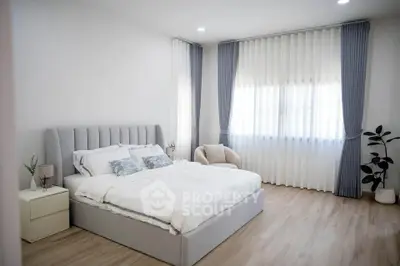 Spacious and elegant bedroom with modern decor and natural light