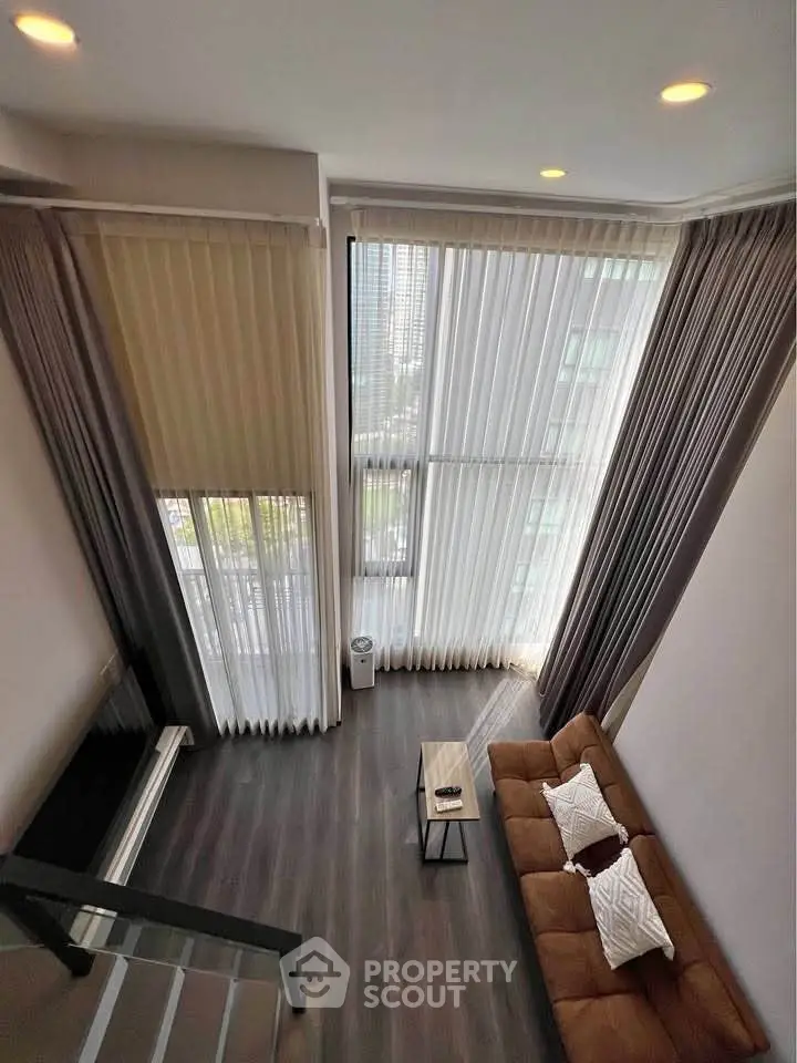 Spacious modern living room with high ceilings and large windows