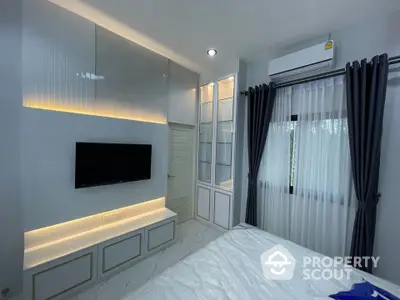 Modern bedroom with sleek design, built-in TV, and ambient lighting