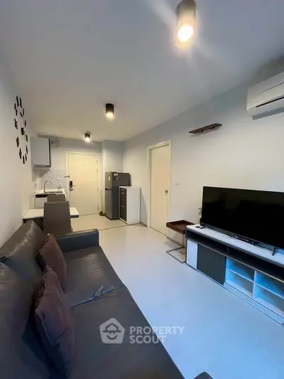 Modern living room with sleek furniture and open kitchen layout