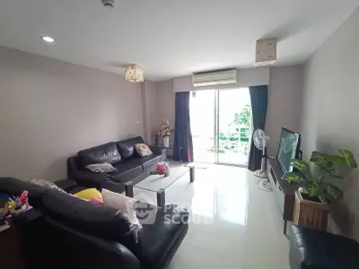 Spacious living room with modern furniture and balcony view in a stylish apartment.
