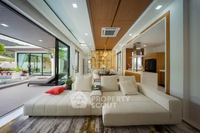Luxurious open-plan living room with pool view and modern decor