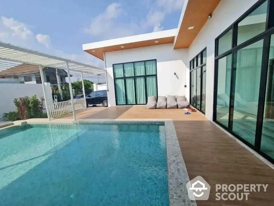 Modern villa with private pool and spacious patio in sunny setting