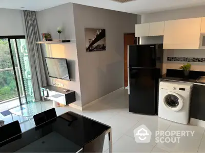 Modern open-layout kitchen and living area with balcony view