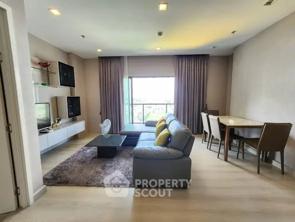 Spacious living room with modern decor and large window view