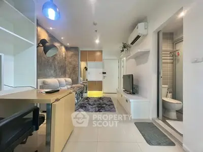 Modern living room with stylish decor and open layout, featuring a cozy seating area and sleek furnishings.
