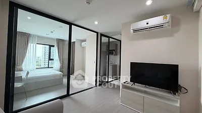 Modern apartment with glass partitions and sleek furnishings