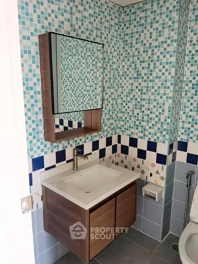 Modern bathroom with stylish mosaic tiles and sleek vanity unit