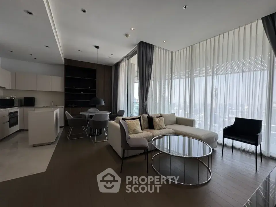 Modern open-layout living room with floor-to-ceiling windows and stylish furniture.