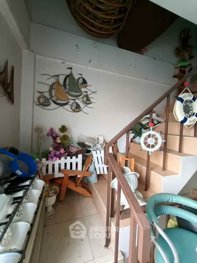 Charming nautical-themed staircase with decorative elements and cozy seating area.