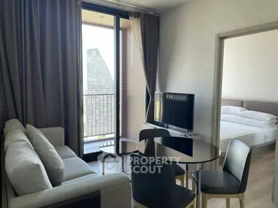 Modern living room with balcony view and adjacent bedroom in stylish apartment.