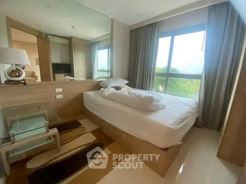 Modern bedroom with large window and stylish decor