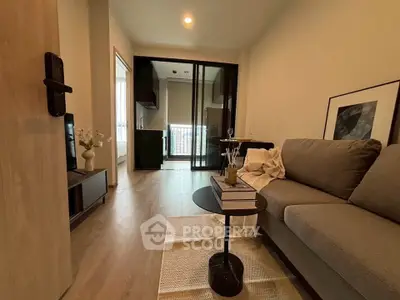 Modern living room with cozy sofa and elegant decor, featuring a sleek open layout and stylish flooring.