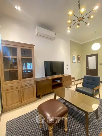 Charming living room with modern furniture and stylish lighting, perfect for relaxation and entertainment.
