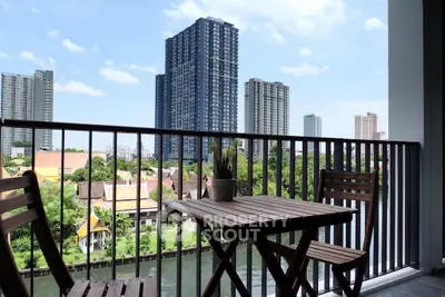 Stunning balcony view with city skyline and river, perfect for relaxation.
