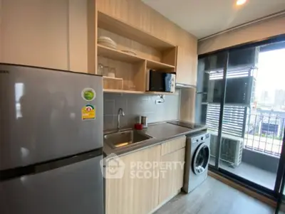 Modern kitchen with wooden cabinets, stainless steel fridge, and washing machine, featuring a balcony view.