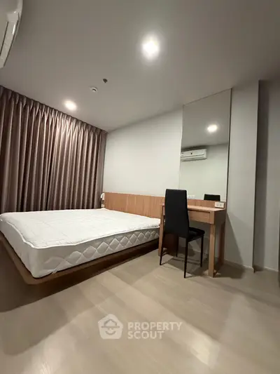Modern minimalist bedroom with sleek furniture and natural light