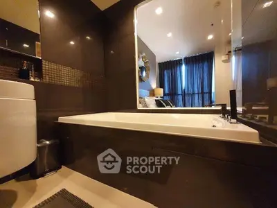 Luxurious bathroom with modern bathtub and elegant decor in upscale apartment.